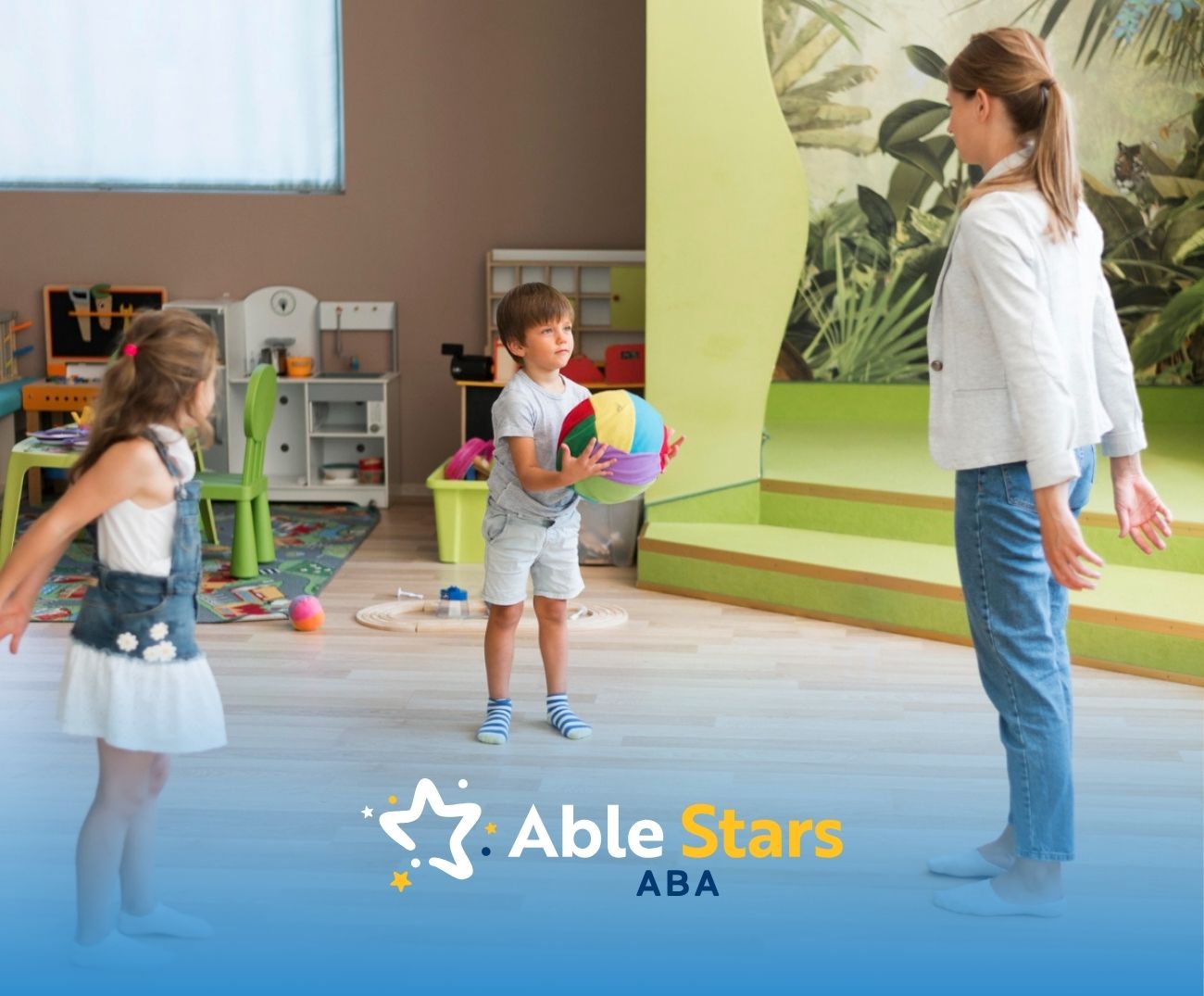 ABA therapist and two kids playing with a ball.