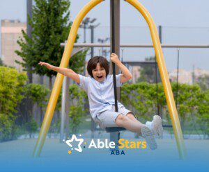 Autistic child enjoying a swing ride outdoors.