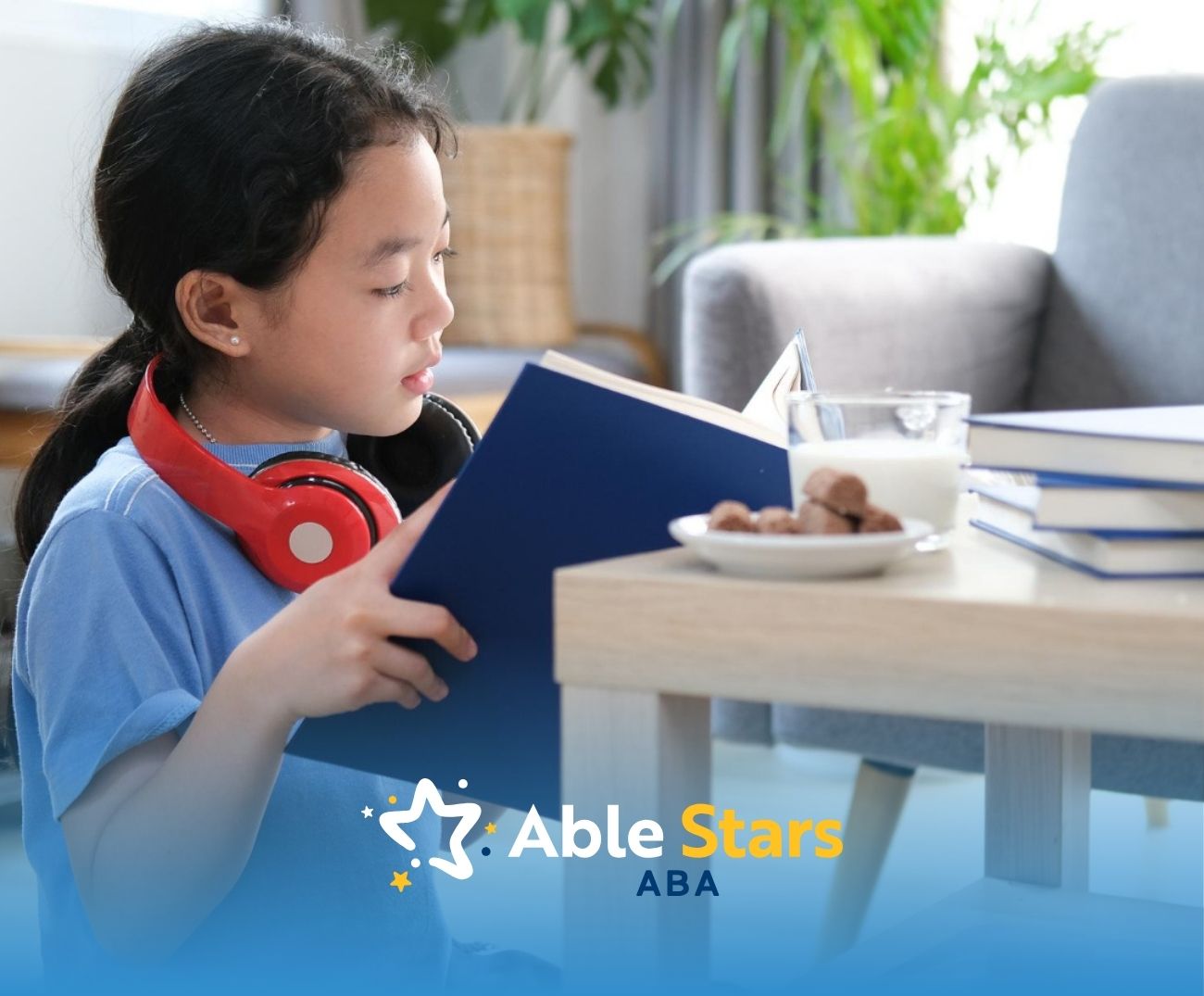 Autistic girl is reading a book with headphones on.