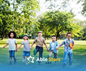 A group of children holding hands and walking together through a park.