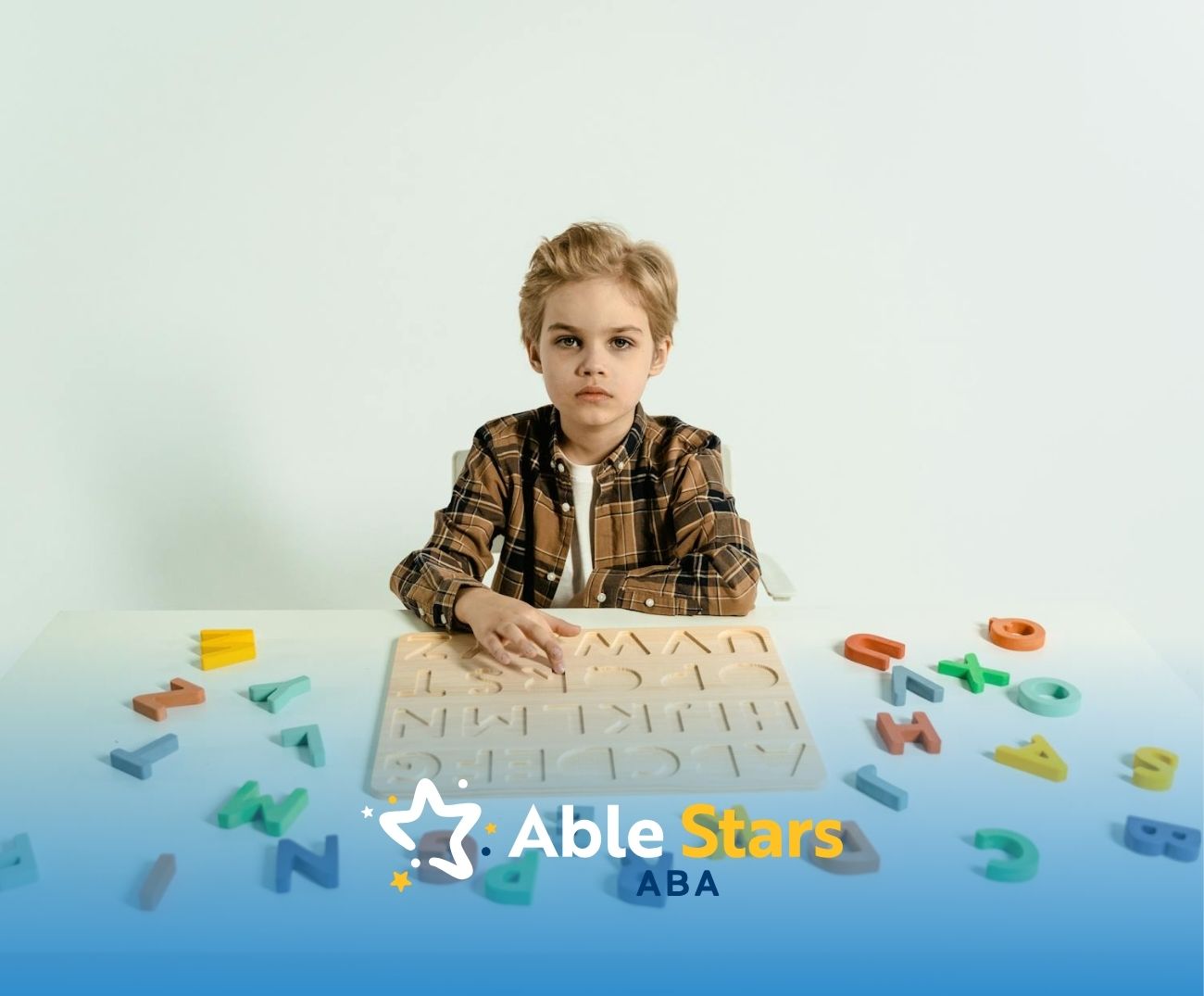 An autistic child sitting at a table with wooden alphabet puzzle and scattered letters in Maryland.