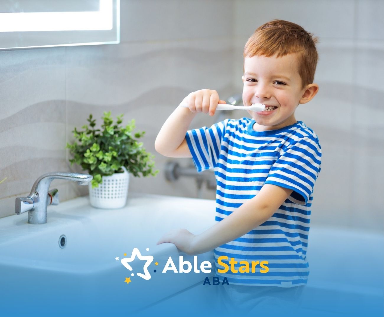 Smiling boy brushing his teeth at a bathroom sink.
