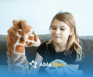 Autistic girl sitting on couch playing with stuffed giraffe and holding a bunny toy at home in MD.