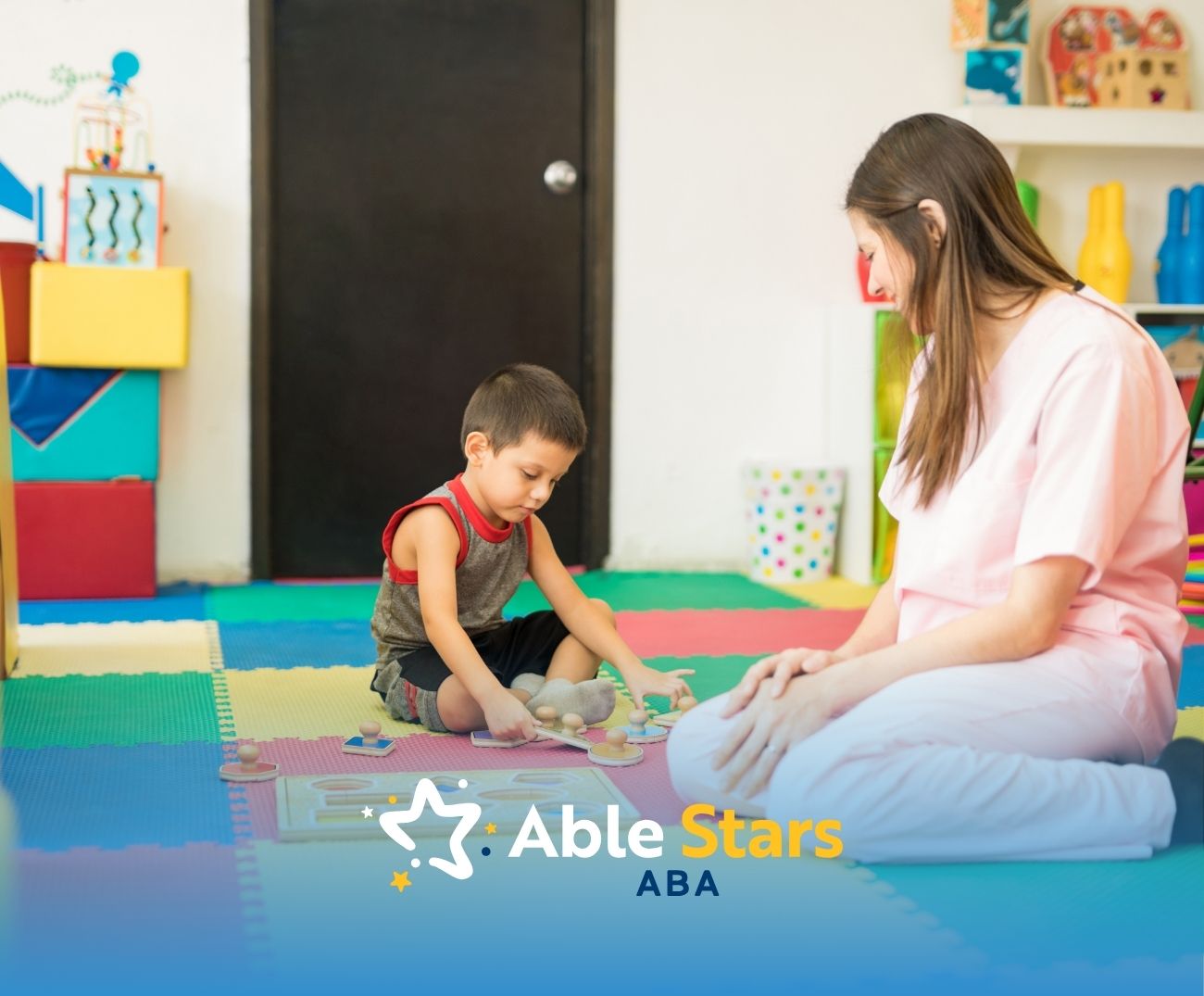 A little boy playing with his mother in a playroom