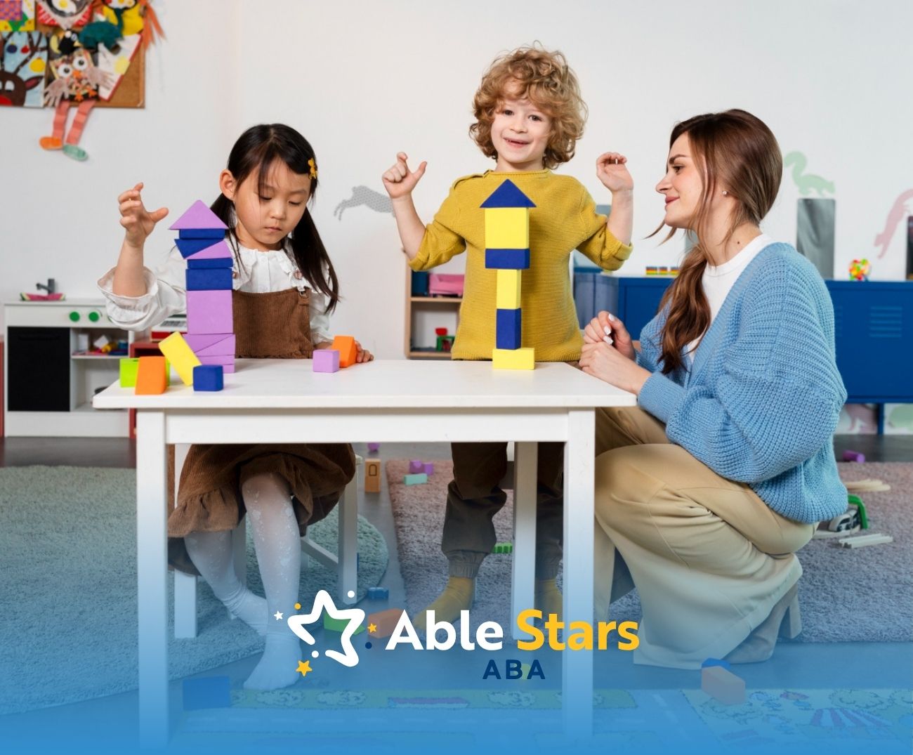 Two autistic children in Maryland building structures with blocks while being guided by an ABA therapist.