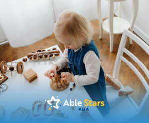 Toddler girl playing with wooden educational toys at a white table