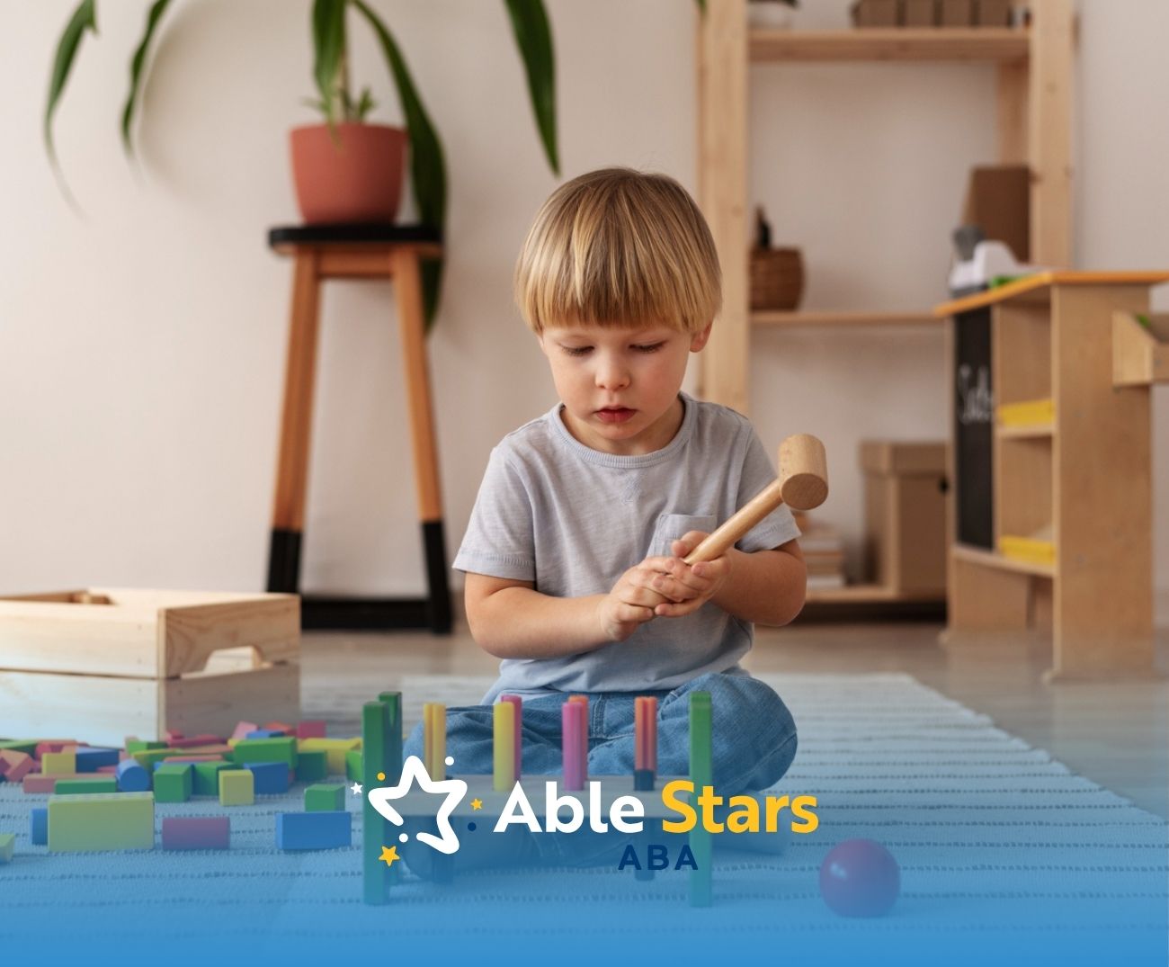 Autistic child in Maryland playing with a wooden hammer and colorful blocks.