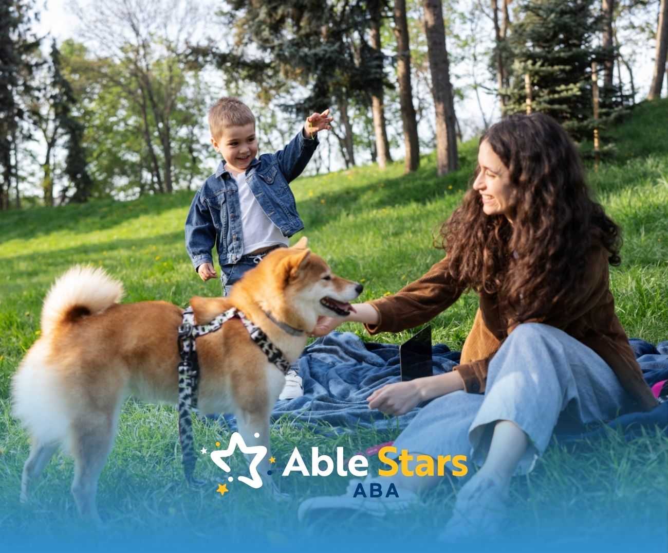 Mother and autistic son playing with a dog in a grassy park.