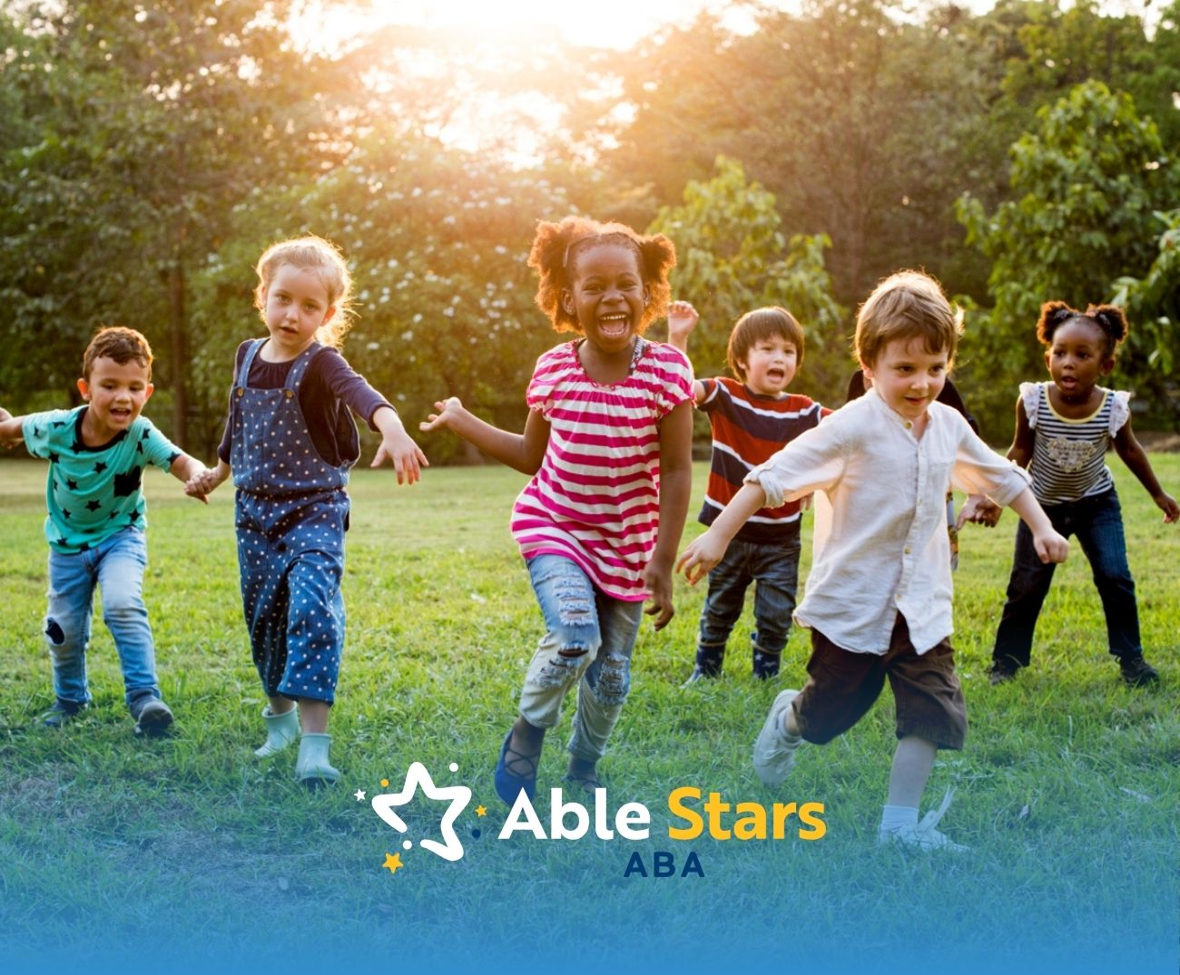 Children running joyfully outdoors holding balloons in a park.