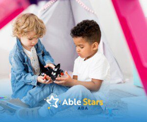 Two autistic children building with toy blocks inside a play area.