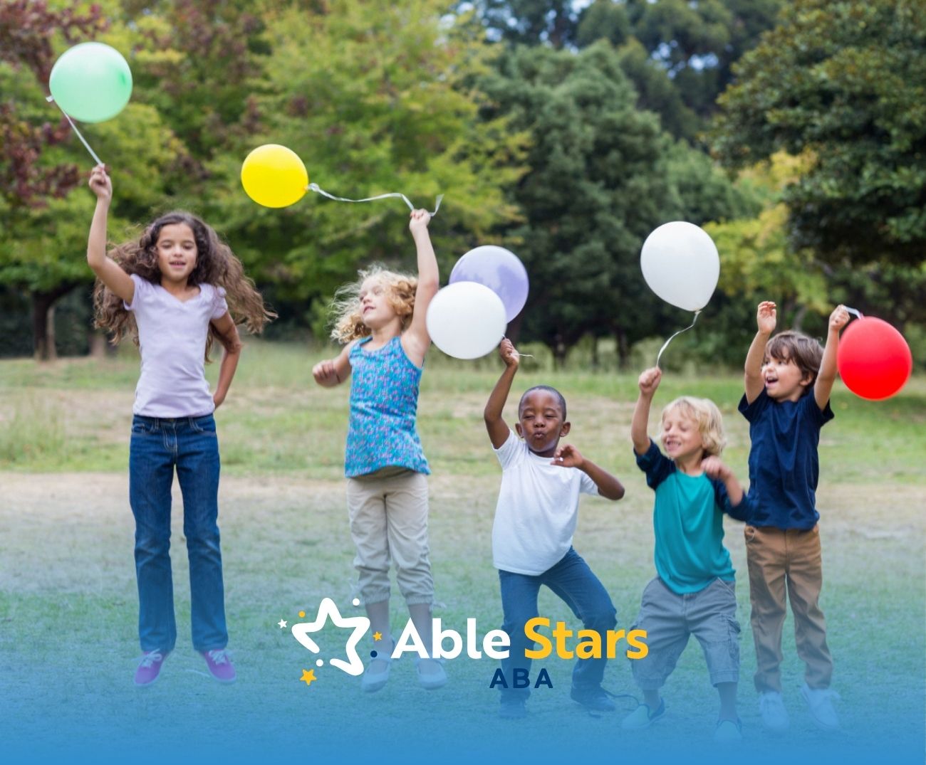 Children running joyfully outdoors holding balloons in a park.