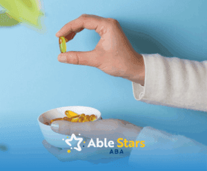 A hand holding a bowl of supplements