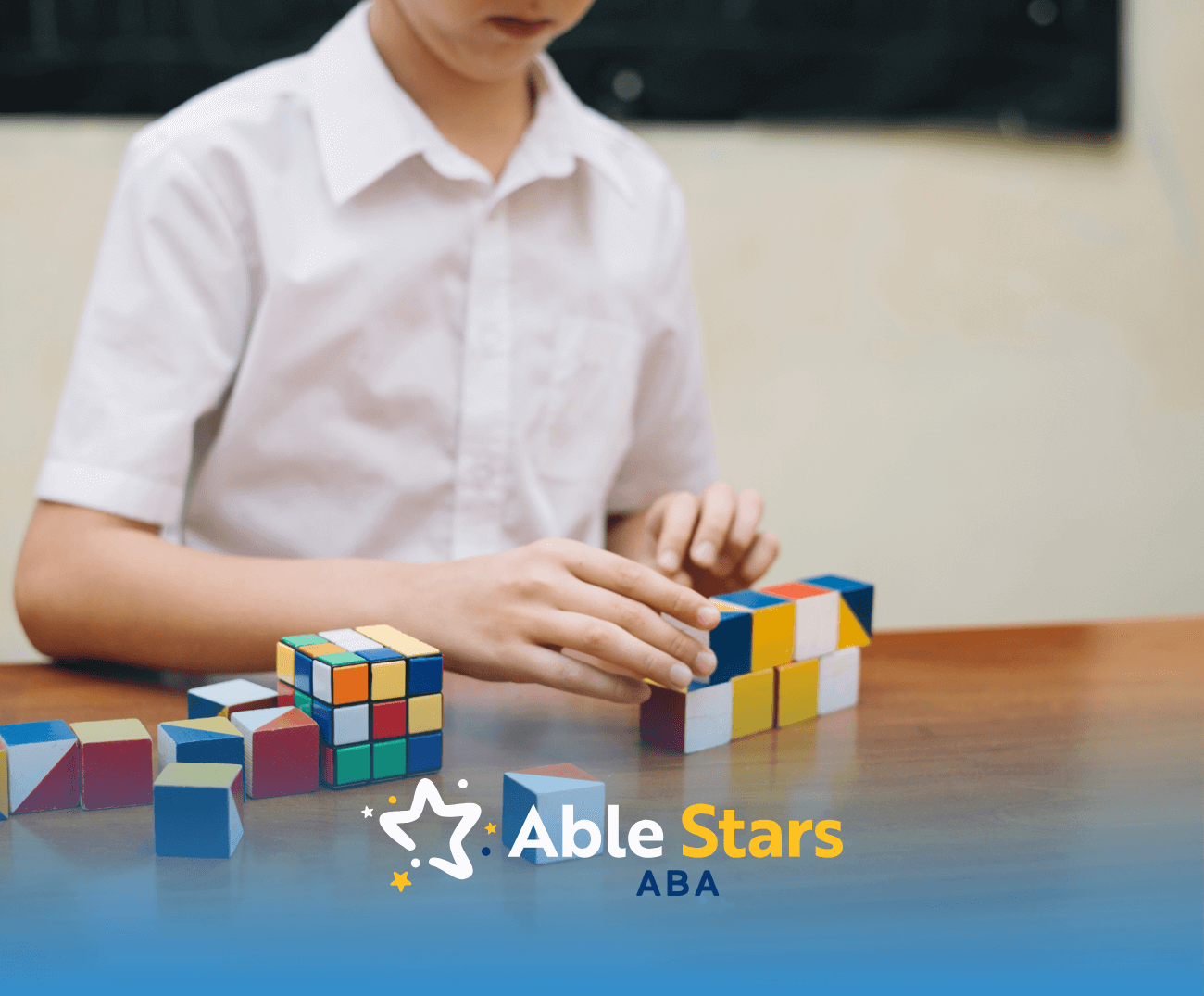 A person with autism playing with rubik's cubes on a tables