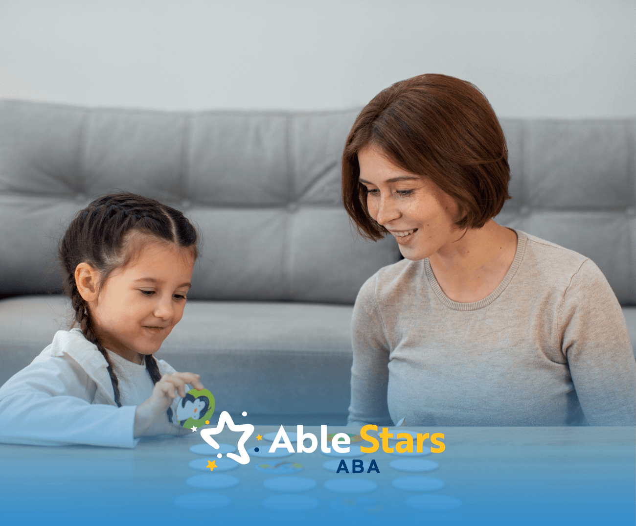 An ABA therapist and a girl with autism talking during ABA therapy
