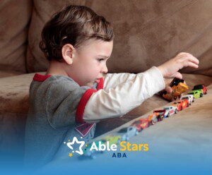 A little boy playing miniature cars.
