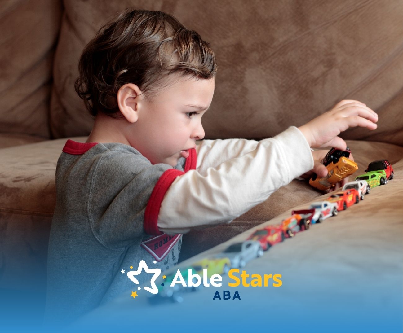 A little boy playing miniature cars.