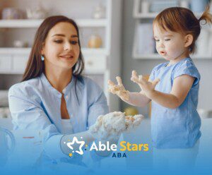 BCBA and toddler playing with dough in an ABA center.