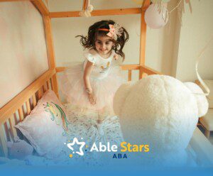 Autistic girl in a tutu jumping joyfully on her bed with a big white teddy bear in Maryland.
