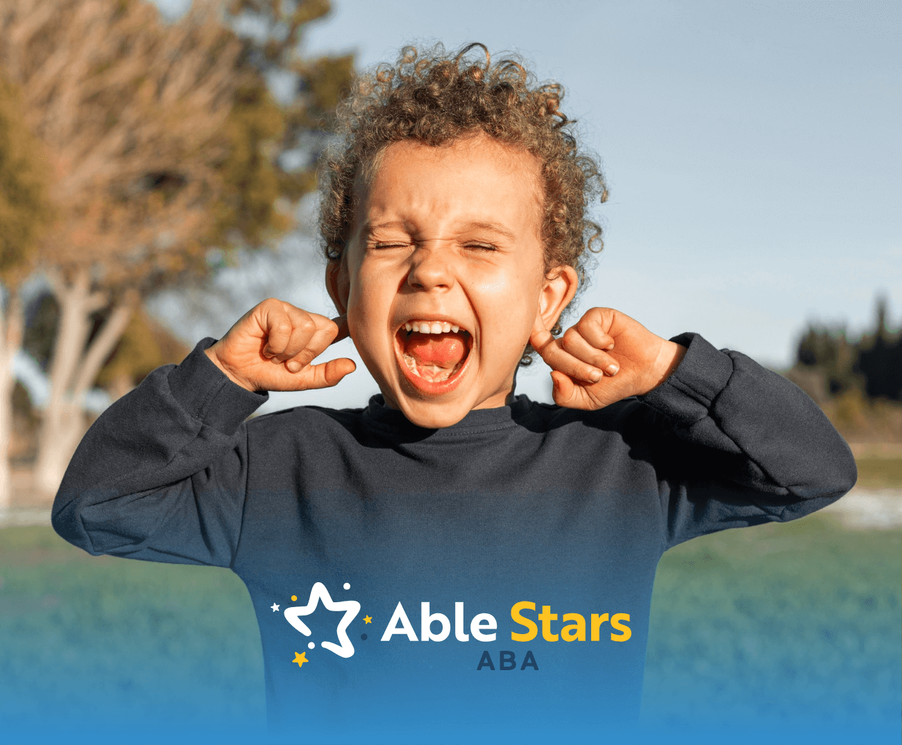 A boy with his fingers on his ears while shouting