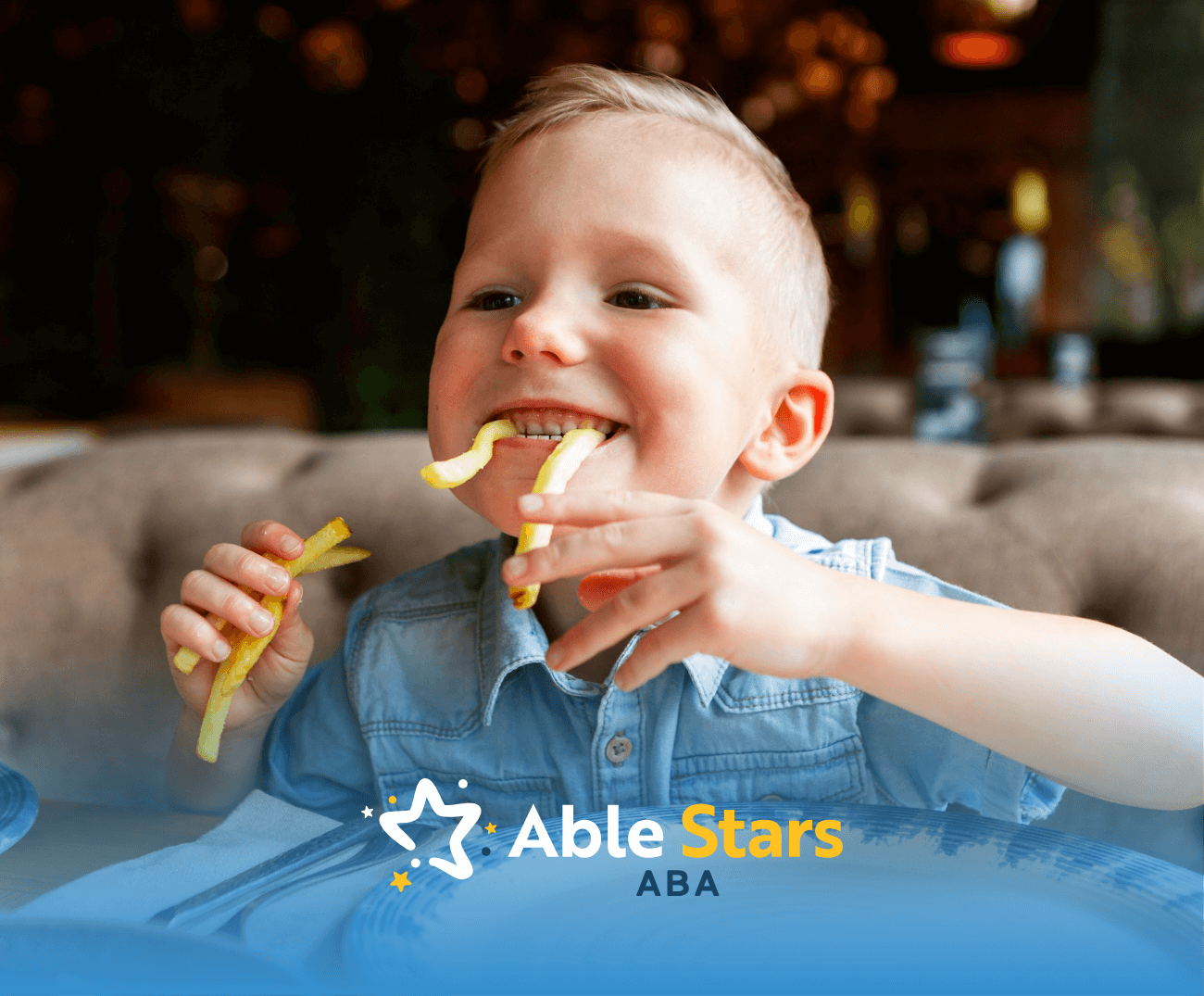 A boy with autism is playfully eating his fries