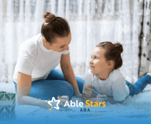 A child and her RBT lying on the floor while talking during their ABA therapy session