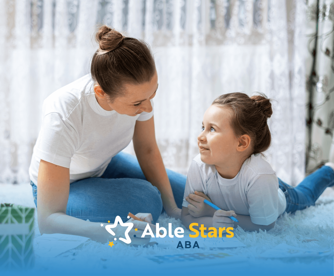 A child and her RBT lying on the floor while talking during their ABA therapy session