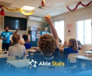 A lively classroom scene with a diverse group of students raising hands. A teacher in a blue shirt gestures, engaging young learners. Holiday decorations hang from the ceiling.