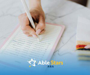 An autistic person handwriting a task checklist on a notepad to properly track progress during ABA therapy in MD.