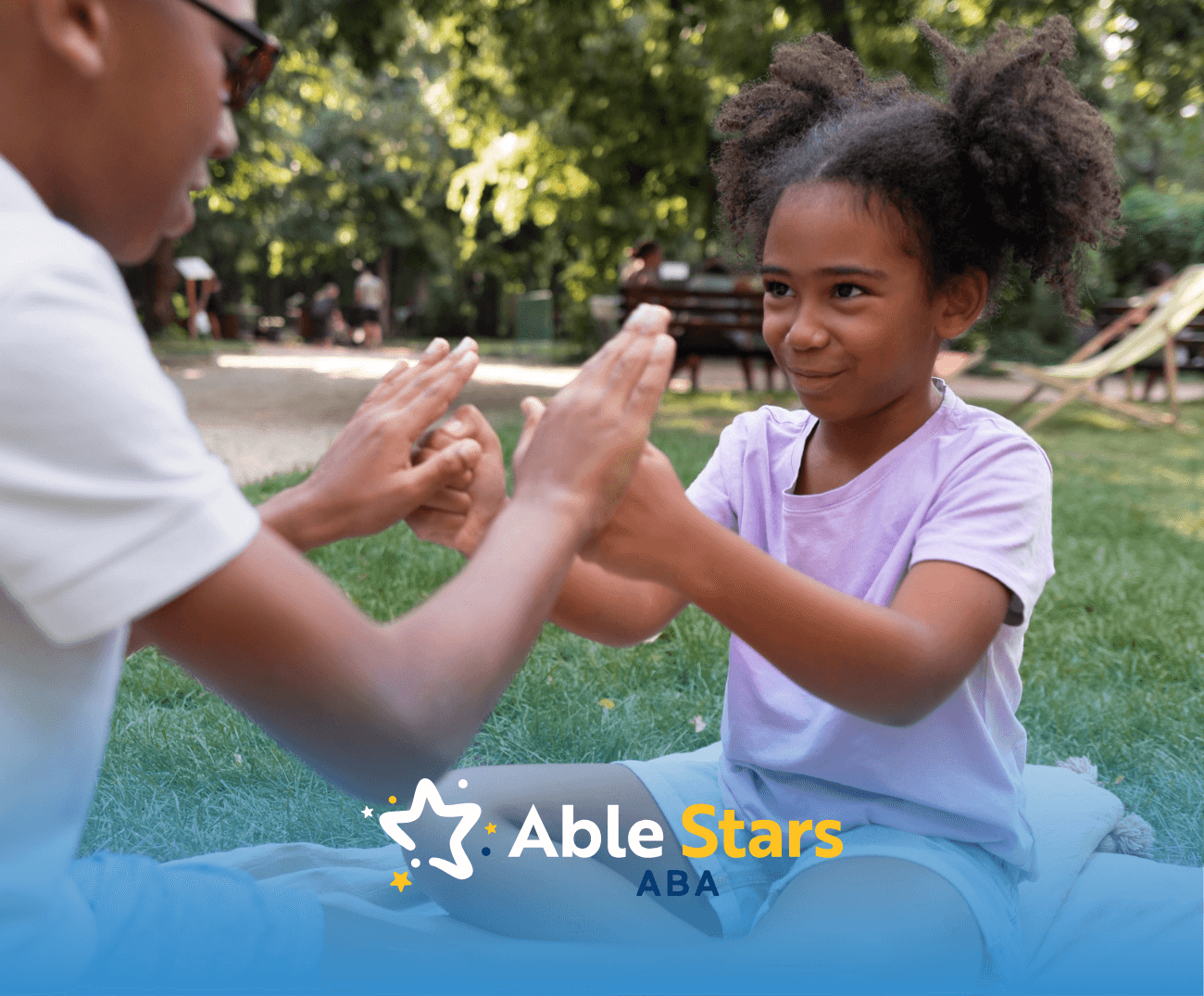 A child with autism high-fiving her ABA therapist during their ABA therapy session outdoors