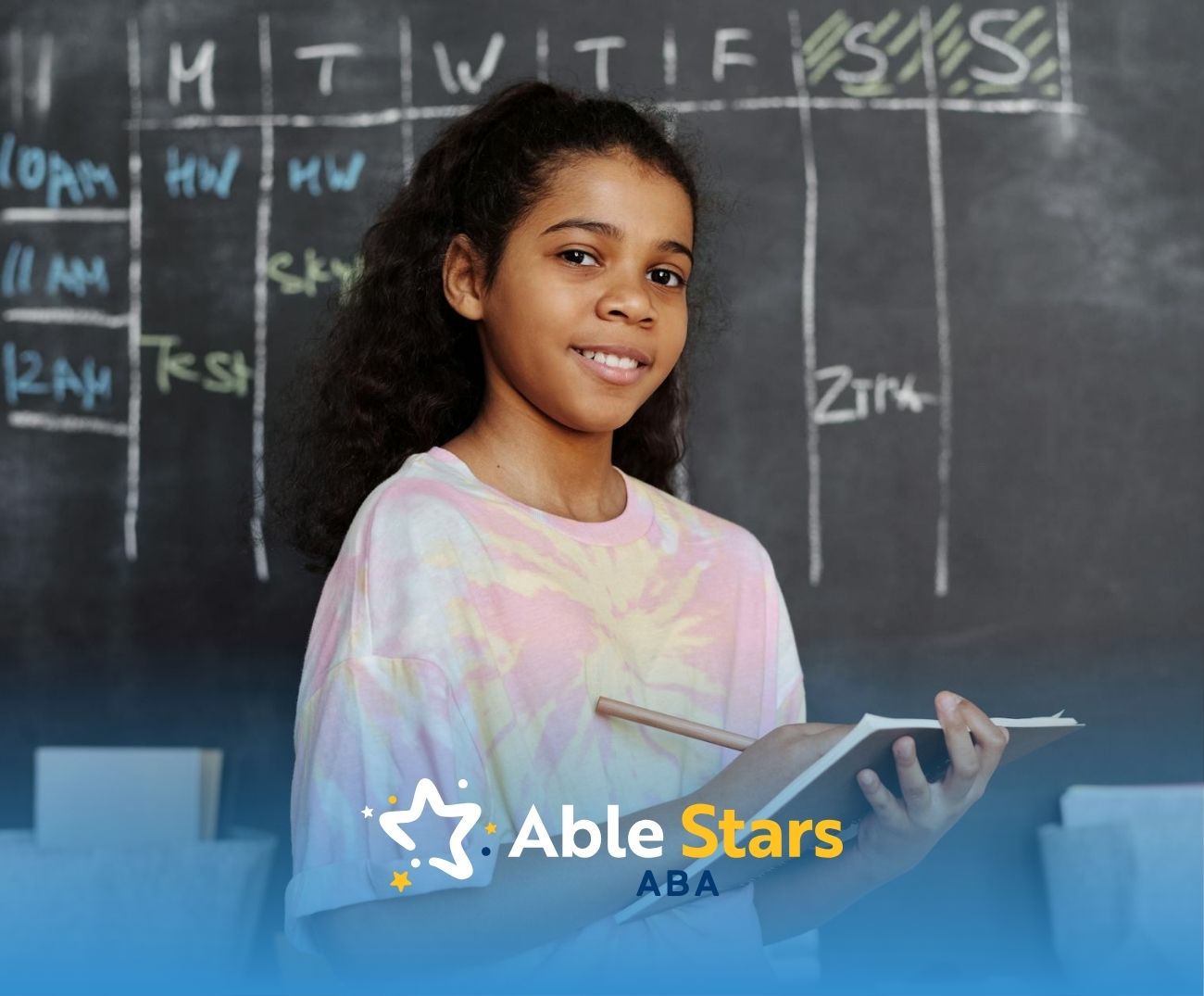 A nonverbal autistic girl with high IQ smiling while holding notebook in front of classroom schedule on chalkboard in MD.