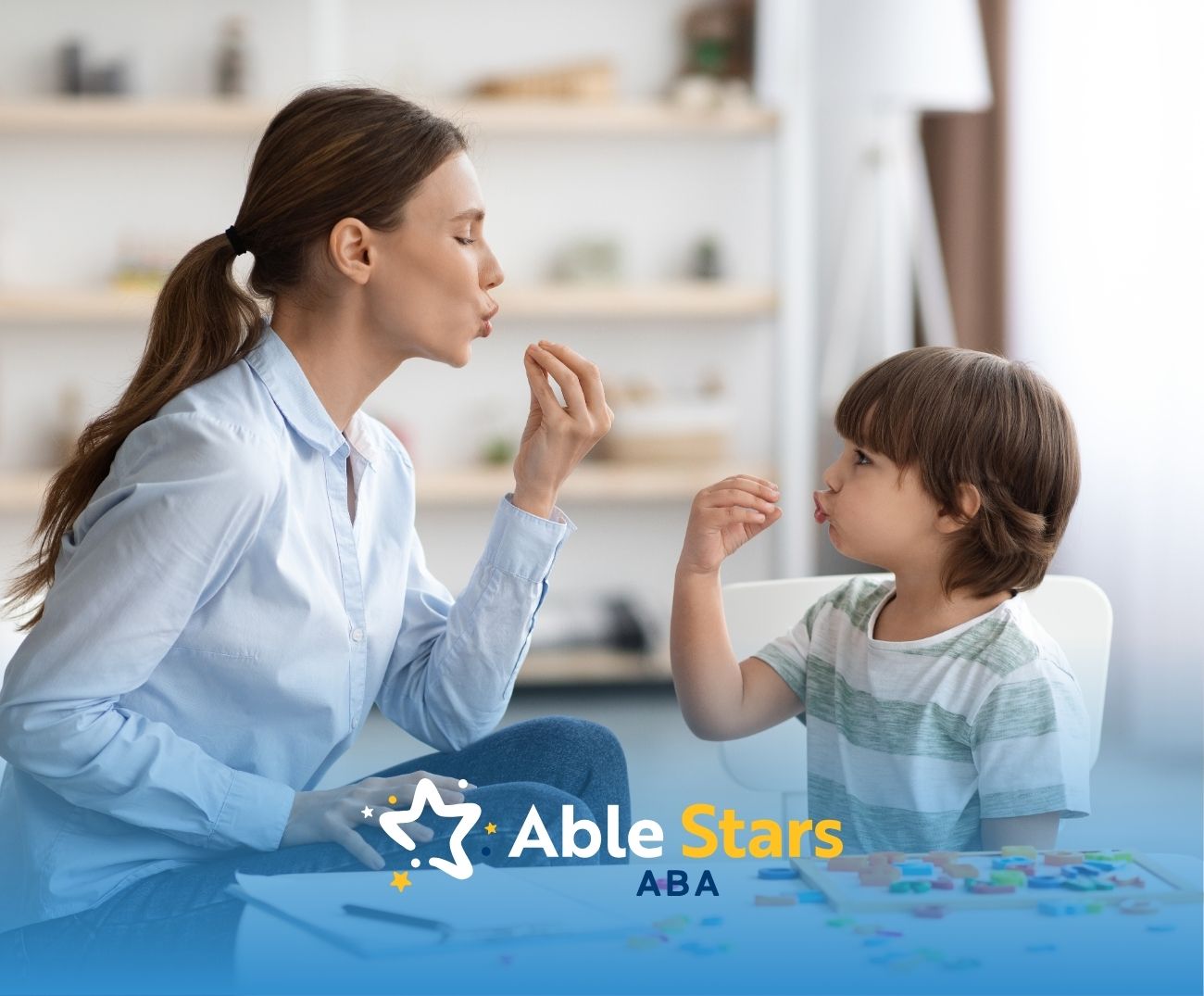 Woman and child sit facing each other, imitating lip movements in a bright room.