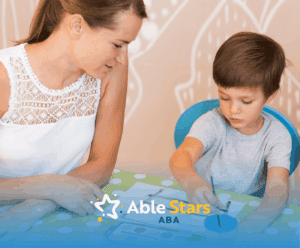 An RBT is teaching a boy with autism during their ABA therapy session