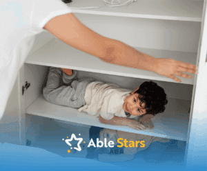 A father is looking at his two kids with autism hiding inside a cabinet