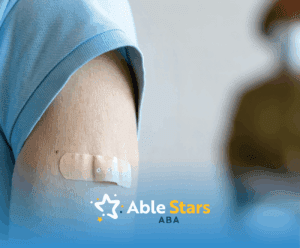 An arm of a child with an adhesive bandage after an immunization shot