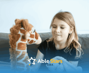 An autistic girl playing with a giraffe and bunny stuffed toys on a bed, making a face during ABA therapy in Maryland.