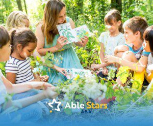 ABA therapist showing plant drawings to children with autism during an outdoor nature session.