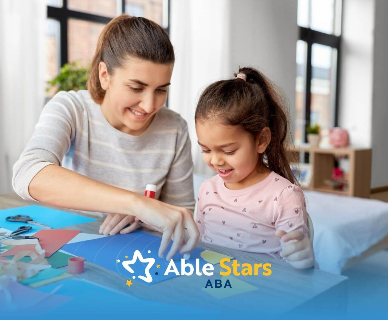 A BCBA and an autistic girl crafting together in ABA therapy.