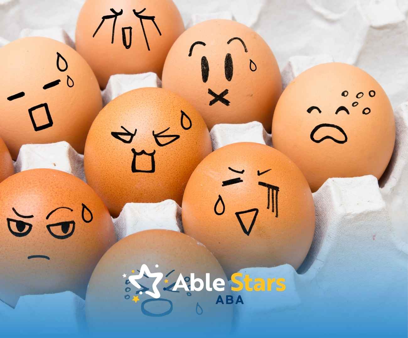 Carton of eggs with drawn expressive faces depicting various emotions like surprise, anger, and sadness.