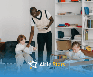 A behavior therapist handing worksheet to autistic child during an in-home ABA therapy session in Maryland.