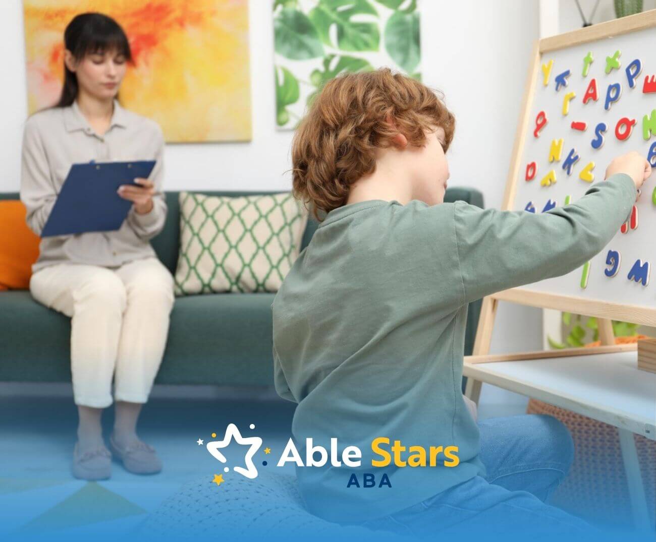 Child arranging magnetic letters on a board while an ABA therapist observes with a clipboard.