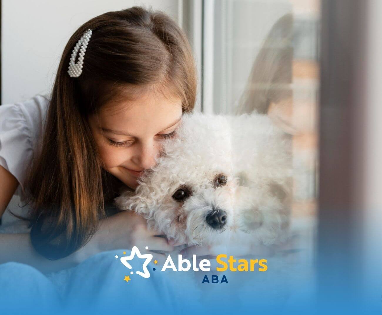 A girl with autism hugging a white fluffy dog by a window.