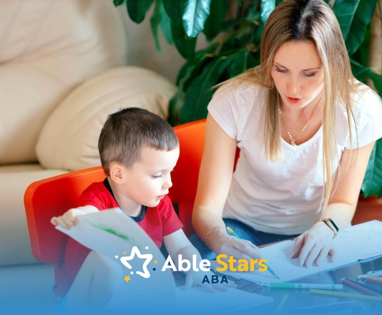 An ABA therapist working on a drawing activity with a child in ABA therapy.
