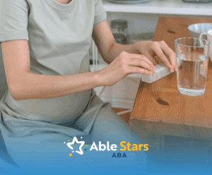 Pregnant woman preparing Tylenol pills at table with water even Trump admin boldly posing autism risks.