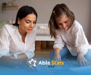 BCBA and girl with autism do puzzle on floor during ABA therapy.