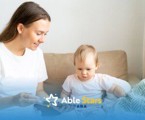 BCBA reads book with small child on couch during ABA therapy.