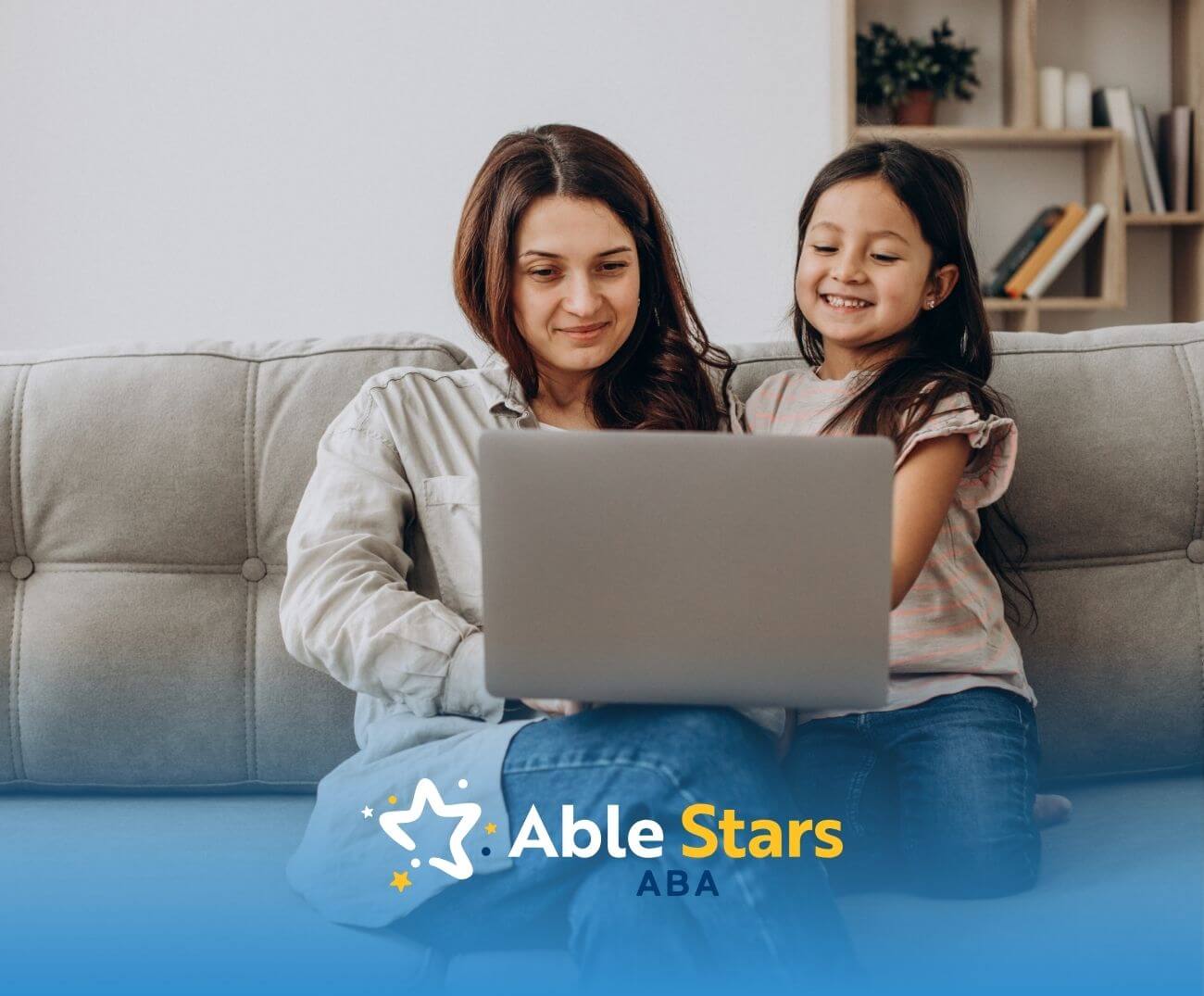 BCBA and girl with autism sitting on a couch using a laptop together.