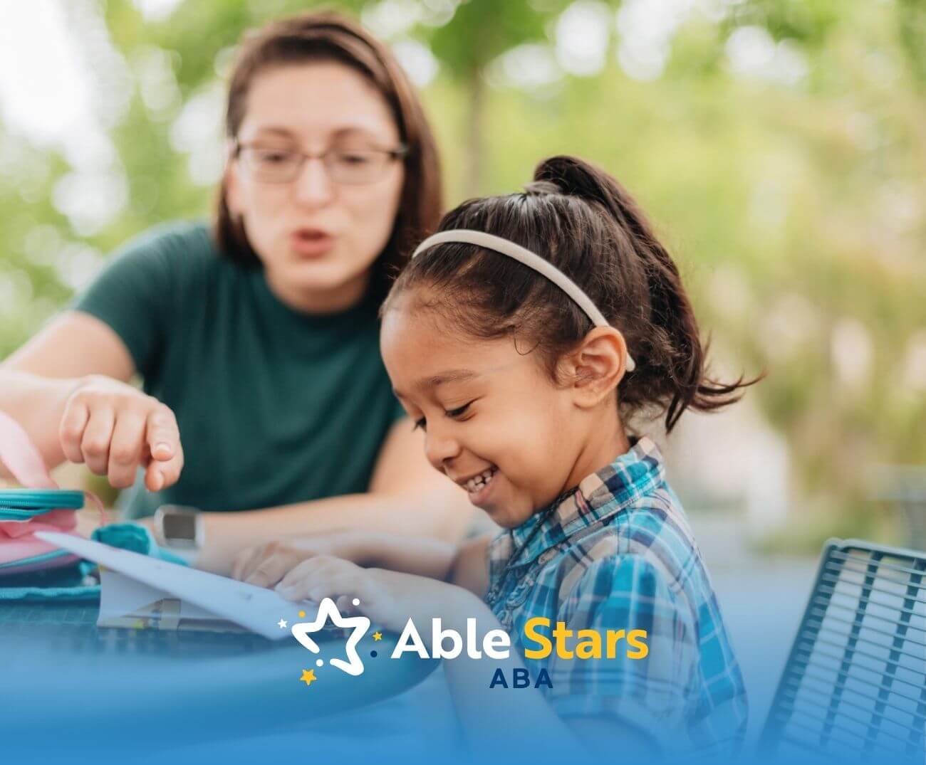 BCBA helps girl with autism read outdoors.