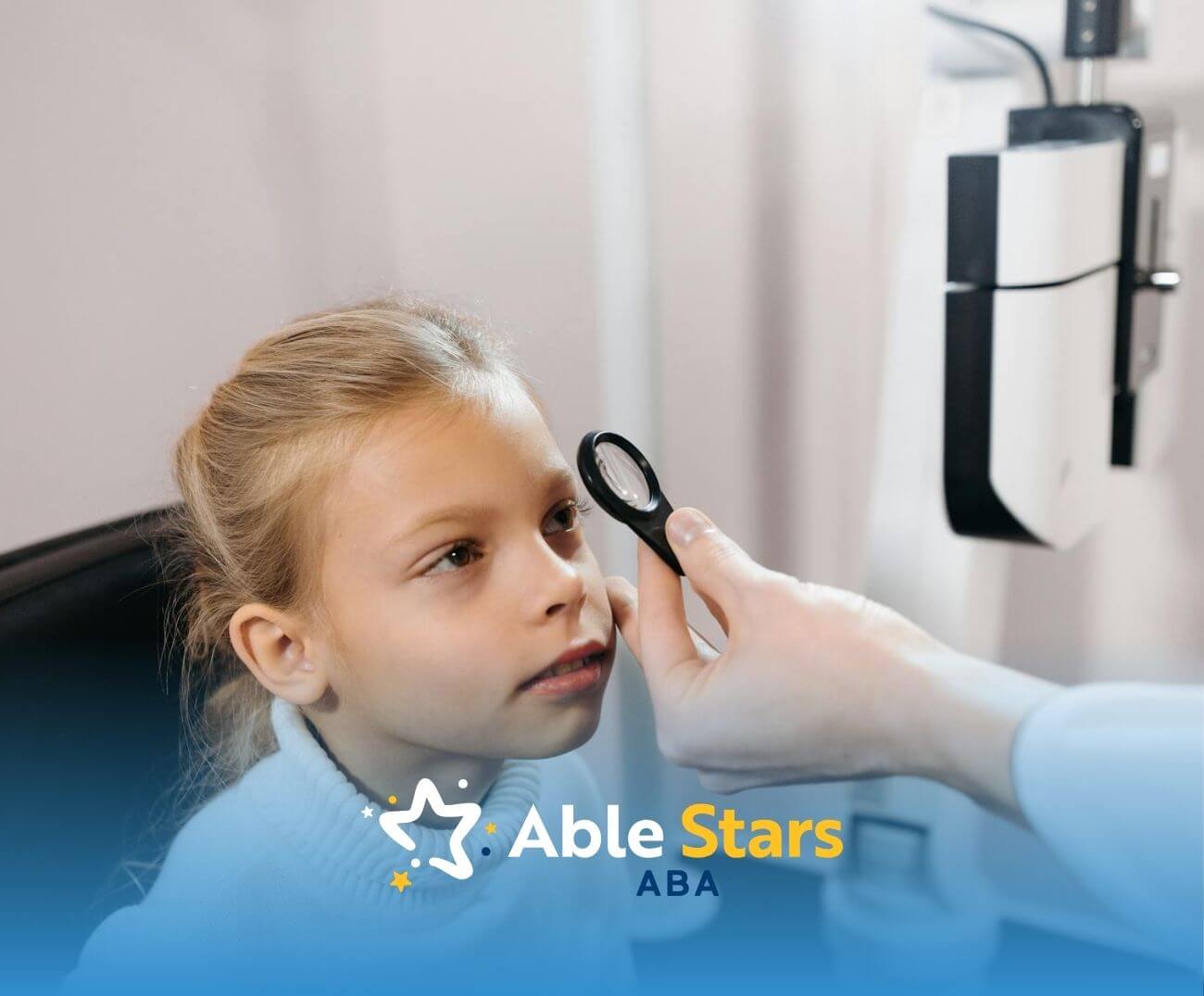 A young girl sits patiently during an eye exam at the doctor’s office, focusing as the physician checks her vision.