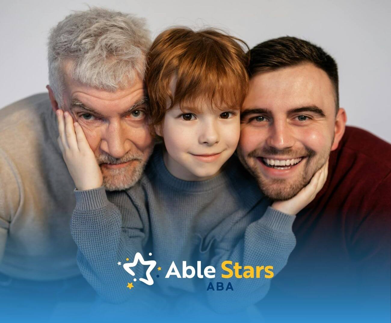 Three men stand close together, smiling warmly for a family portrait that captures their bond, pride, and shared connection.