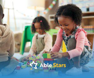 Children play with colorful blocks on a soft, blue mat in a cheerful classroom setting.
